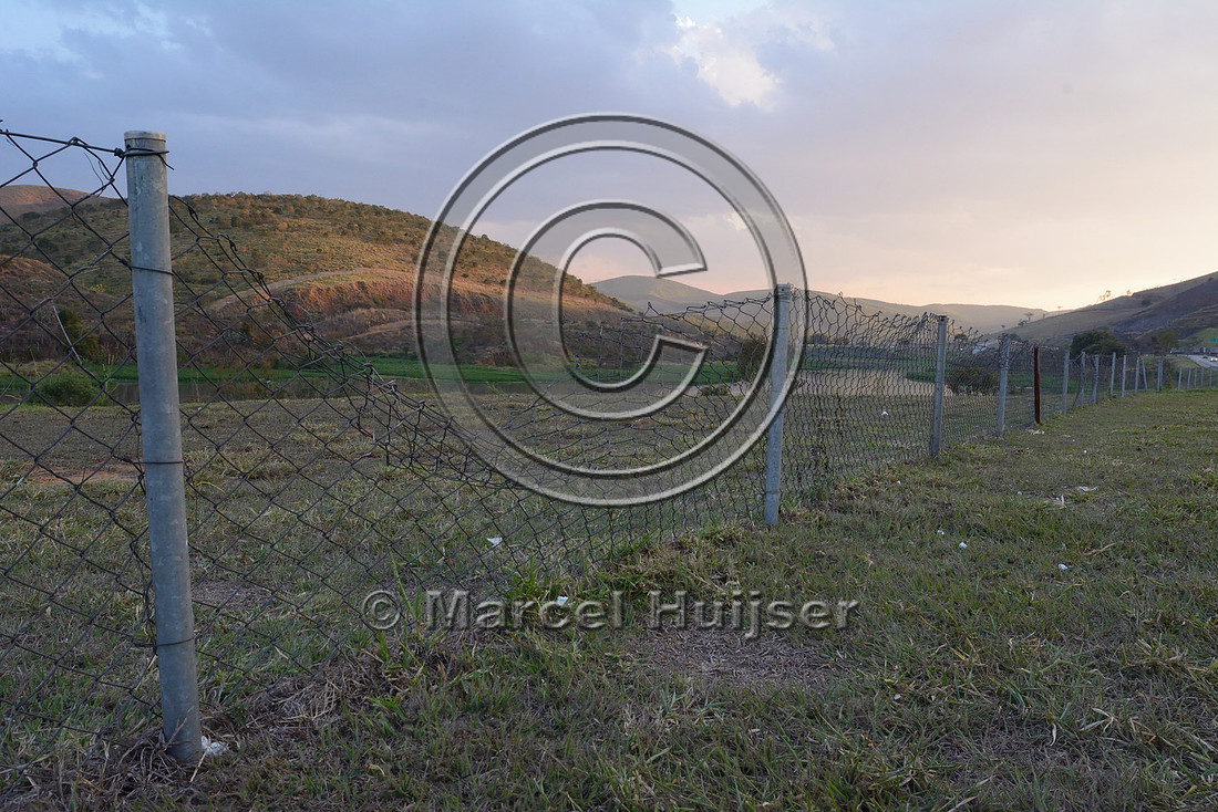 Wildlife fence to keep capybara (Hydrochoerus hydrochaeris) off the highway, with a large gap in the fence, Rodovia Presidente Dutra, (BR-116 – SP-60), near Lavrinhas, São Paulo, Brazil