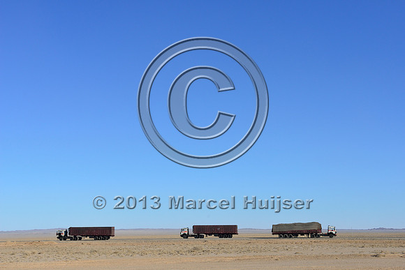 Coal trucks on the paved toll road between Tsagaan khad (White Rock) and Gashuun-Sukhait, Gobi, Mongolia