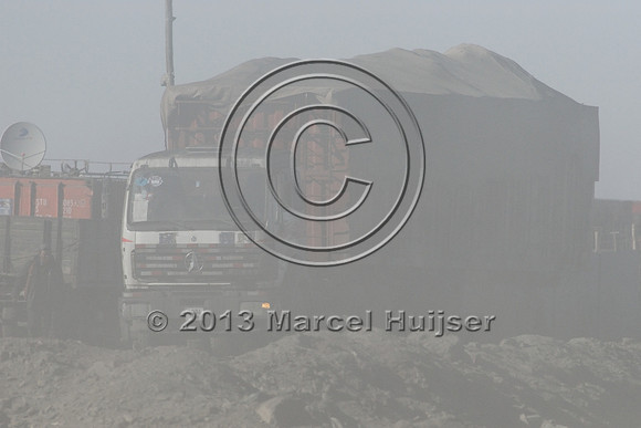 Coal trucks hauling coal to the border and dust, between Tsagaan khad (White Rock) and Gashuun-Sukhait, Gobi, Mongolia
