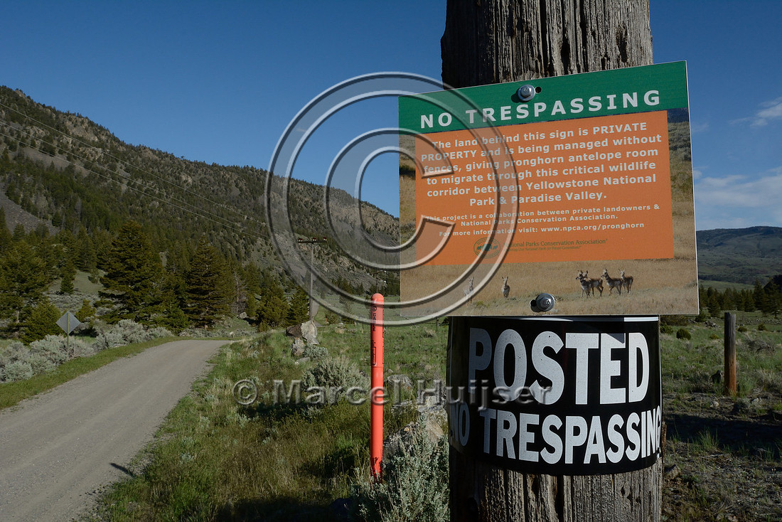 Public road through private lands. This gate and sign mark a a public land / private land boundary along a public road