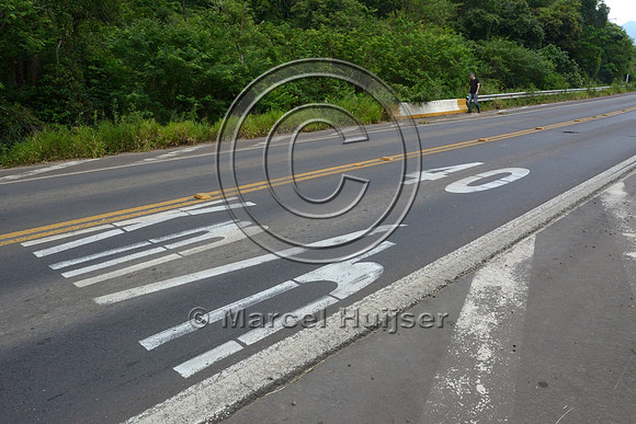 Speed limit reduction to 40 km per h painted on pavement, RS-486, Reserva Biológica Mata Paludosa, Rio Grande do Sul, Brazil