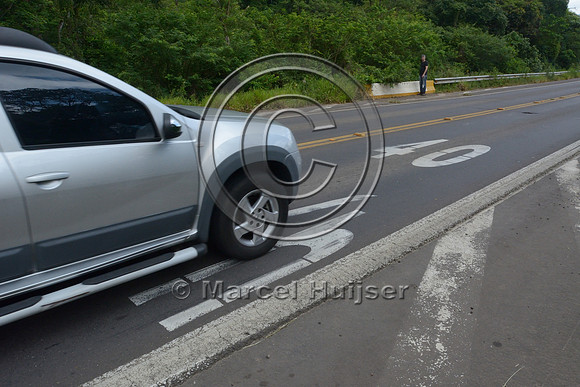 Speed limit reduction to 40 km per h painted on pavement, RS-486, Reserva Biológica Mata Paludosa, Rio Grande do Sul, Brazil