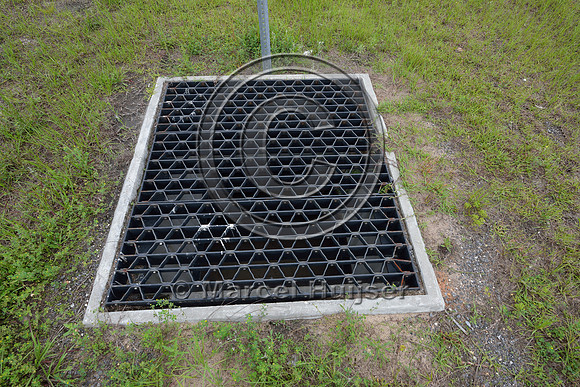 Opening (with bridge grate cover) in median to allow light and moisture in the wildlife underpass, Hwy 331, Hwy 83 near Freeport, Florida, USA