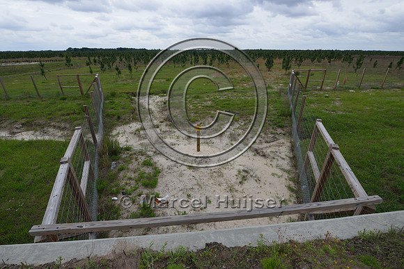 Wildlife fence (smaller mesh size towards bottom) funnels wildlife towards wildlife underpass, Hwy 331, Hwy 83 near Freeport, Florida, USA