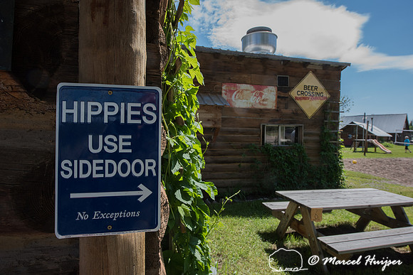 Northern Lights saloon, sign, hippies use side door, Polebridge, Montana, USA
