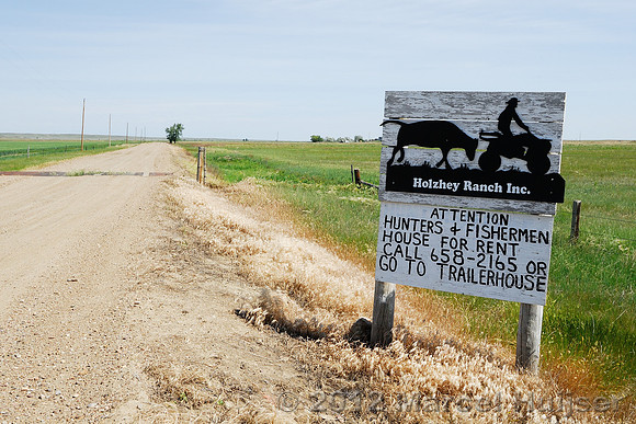Road sign near American Prairie Reserve attention hunters & fishermen, house for rent, near Sun Prairie, Montana, USA