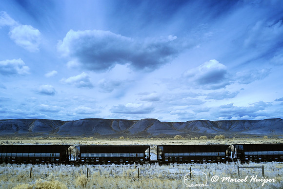 Railroad cars near Bridger, Montana, USA. In super color infrared, R and B channels switched