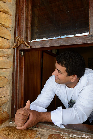 Man at the guard station at Casca D'Anta looks at a giant moth, Parque Nacional Serra da Canastra, Minas Gerais, Brazil