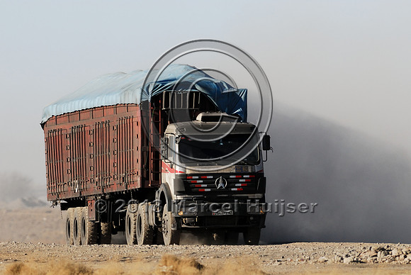 Coal trucks hauling coal to the border and dust, between Tsagaan khad (White Rock) and Gashuun-Sukhait, Gobi, Mongolia
