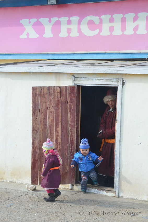 Travel: Children exiting a store, Bayan-Adarga, Khentii, Mongolia.