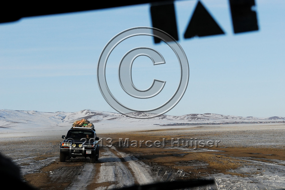 Dirt road and vehicle in winter near Omnodelger, Khentii, Mongolia