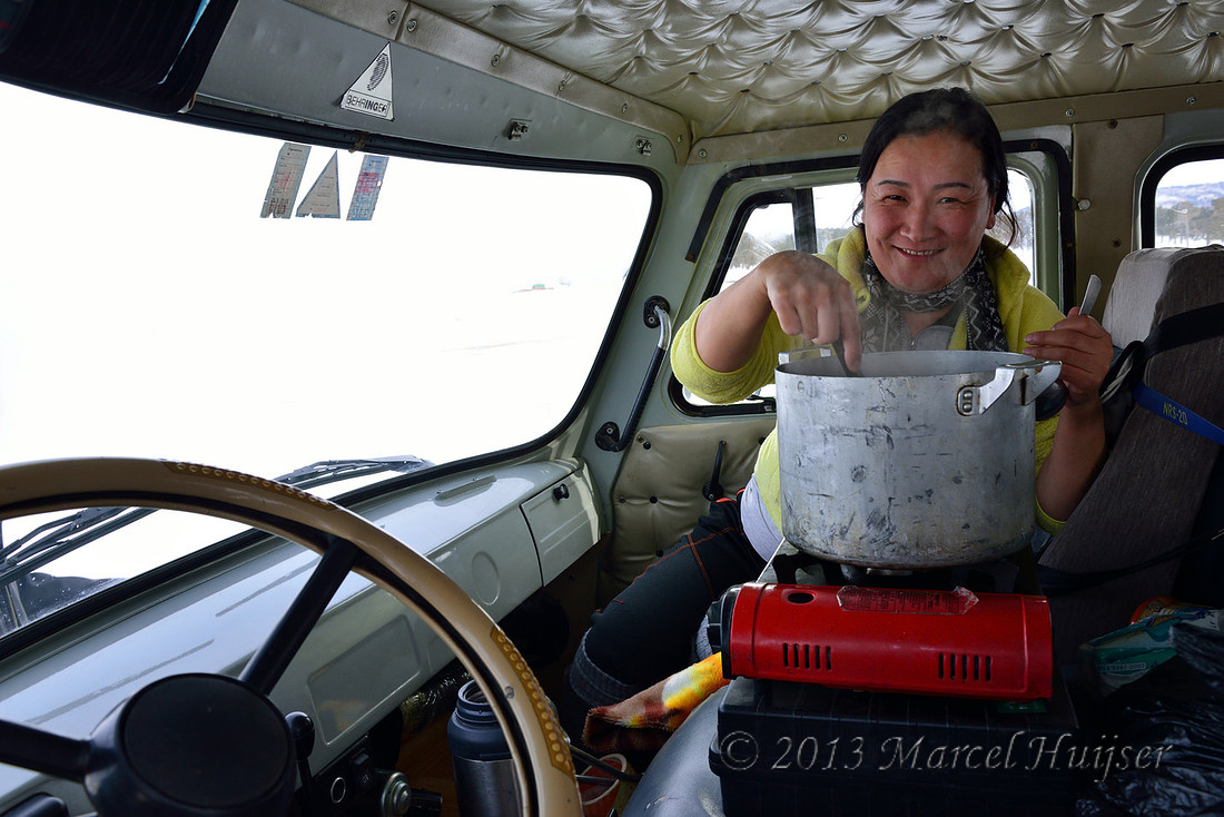 Thuul warms up delicious soup in the Furgon 4wd Russian van, near Bayan-Adarga, Khentii, Mongolia