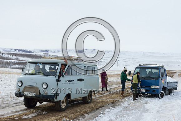 Helping another vehicle get out of a snow bank, near Bayan-Adarga, Khentii, Mongolia