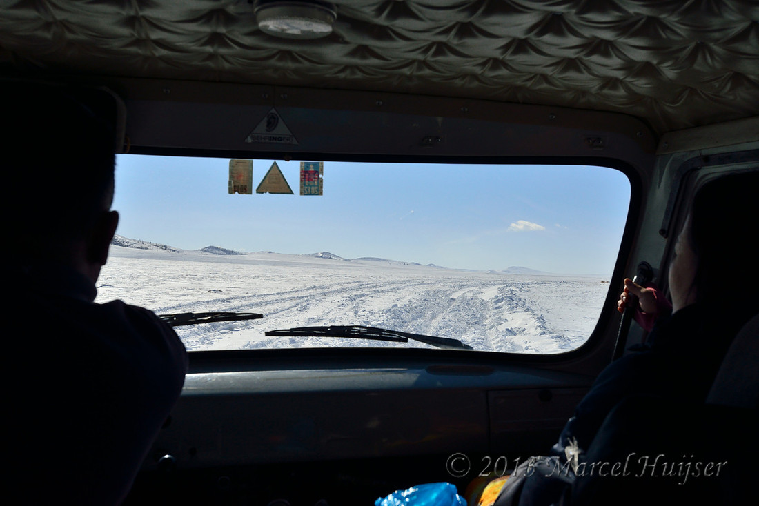 Deep snow covers parallel dirt roads (parallel two tracks) on snow covered grasslands, near Bayan-Adarga, Khentii, Mongolia