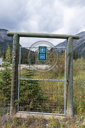 Pedestrian and bicyclist gate at electrified barrier to keep bea