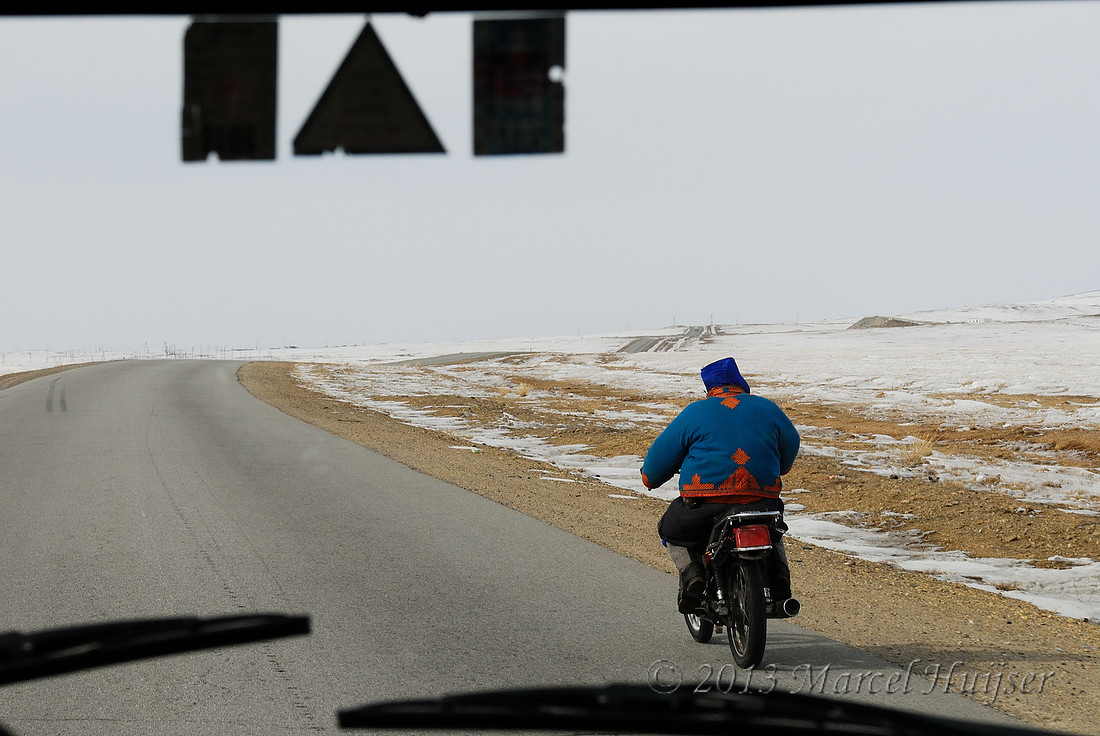 Travel: Motorcyclist along Highway A0101 paralleling Trans-Mongolian Railway, between Choyr and Nalayh, Töv Govisümber, Mongolia