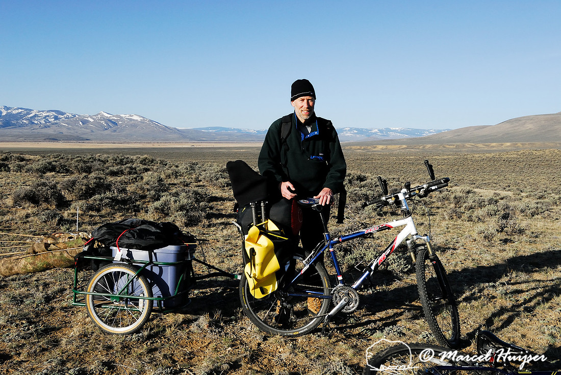 Marcel Huijser and his bicycle and trailer packed with photo and camping gear near a sage grouse (Centrocercus urophasianus) lek, Montana, USA