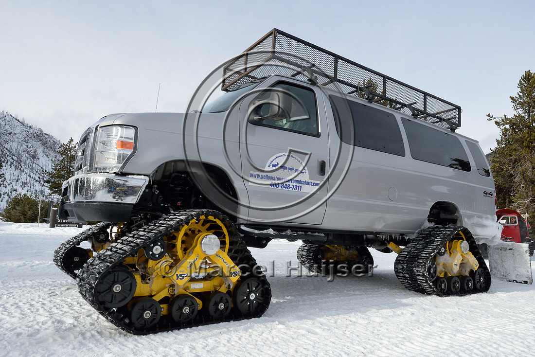 Passenger van with snow tracks, Madison Junction, Yellowstone National Park, Wyoming, USA