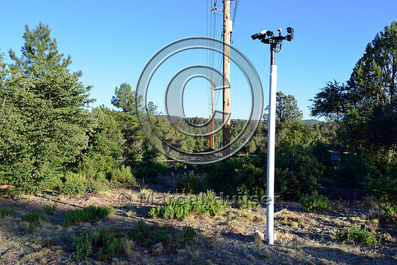 Detection area with sensors and cameras associated with an animal detection and driver warning system at a fence end, S.R. 260 east of Payson, Arizona, USA