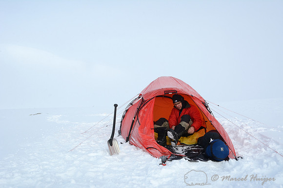 The making of the muskoxen images, camp 2, Dovrefjell National Park, Norway, Niels Kooijman puts on his boots, camp 2, Dovrefjell National park, Norway