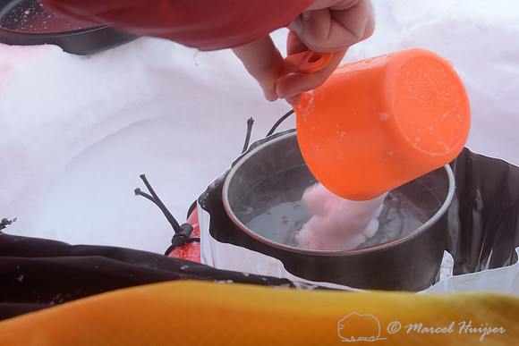 The making of the muskoxen images, Melting snow for cooking and drinking water, camp 1, Dovrefjell National Park, Norway