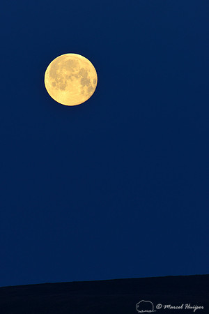 Full moon setting on the horizon, near Bannack, Montana, USA