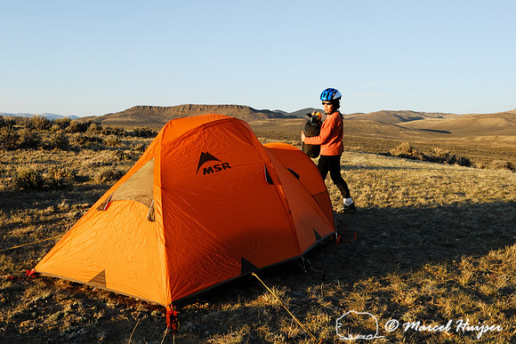 Emiliano Ferguson setting up camp near a sage grouse (Centrocercus urophasianus) lek, Montana, USA