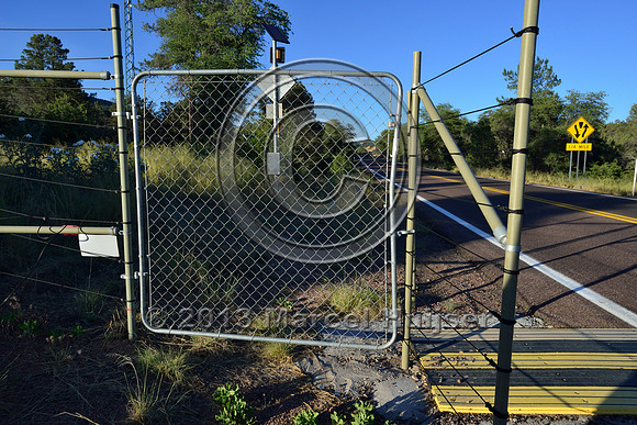 Gate in electric fence associated with an animal detection and driver warning system at a fence end, S.R. 260 east of Payson, Arizona, USA