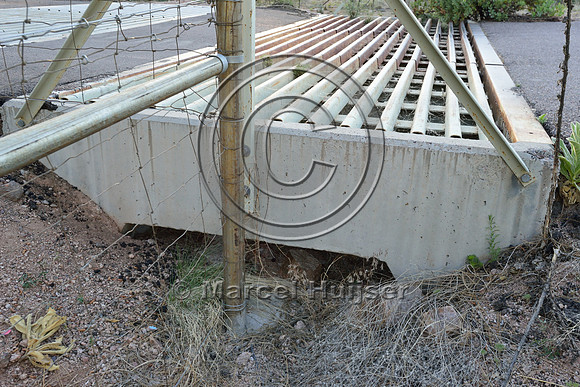Double wide cattle guard as a barrier for deer and elk with drainage and escape for small species, east of Payson, Arizona, USA