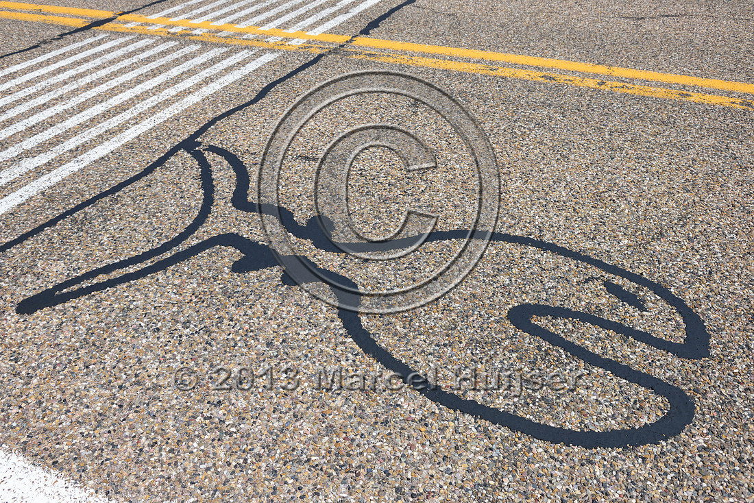 This is what happens when a road repair crew gets creative. Fish drawing with crack filler and sealer, Arizona, USA