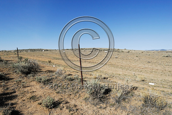 Livestock fence with markers for sage grouse, Montana, USA