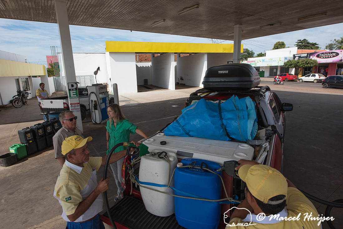 Filling up fuel containers at a gas station, Mitsubishi 4x4, L20