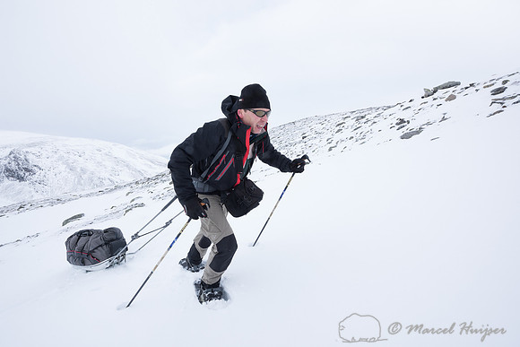 Niels Kooyman drags his sled up a steep slope, Dovrefjell, Norwa