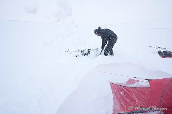 Niels Kooyman digs his sled out of the snow at third camp, Dovre