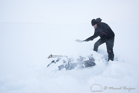 Niels Kooyman digs his sled out of the snow at third camp, Dovre