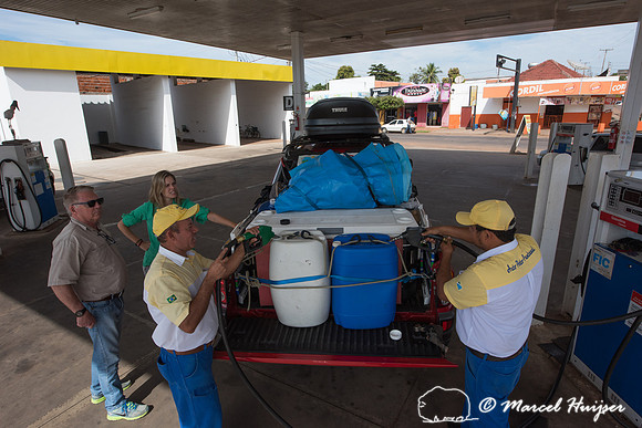 Filling up fuel containers at a gas station, Mitsubishi 4x4, L20