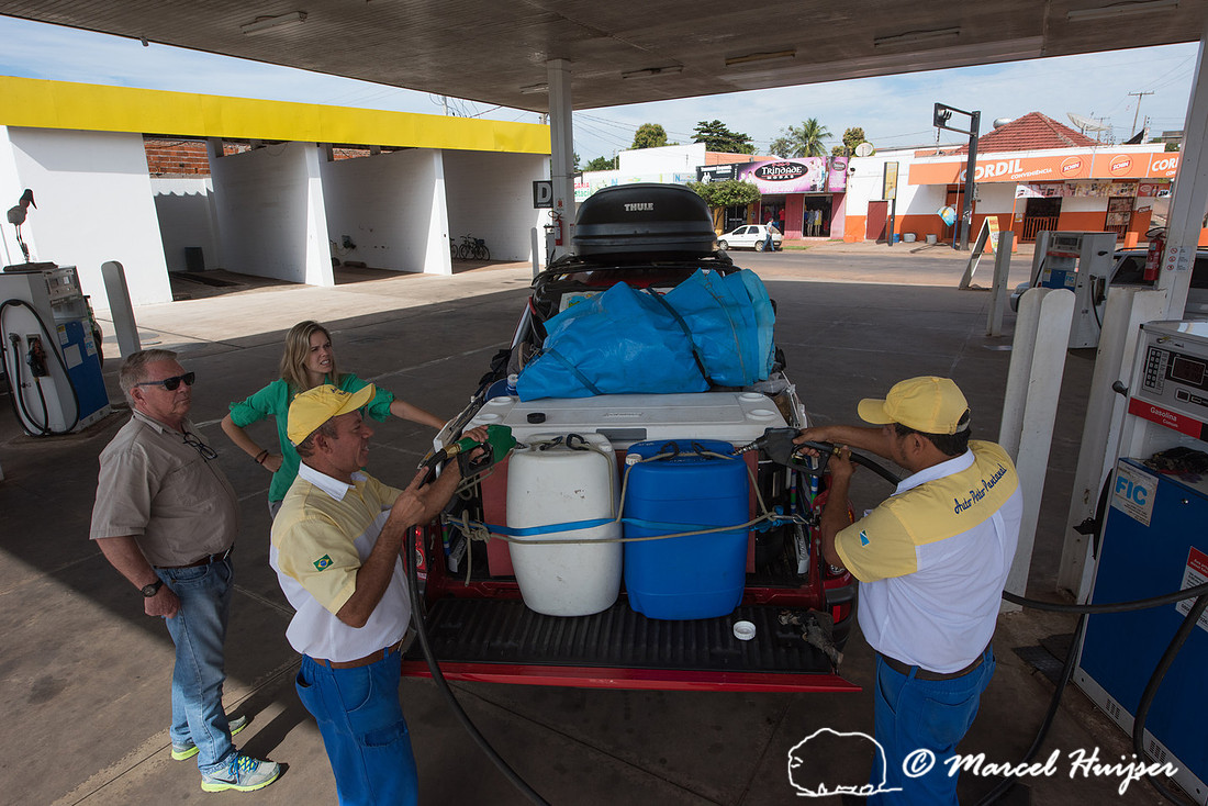 Filling up fuel containers at a gas station, Mitsubishi 4x4, L20