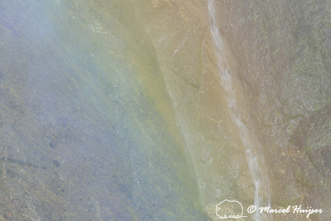 Waterfall through rainbow, Grand Canyon of the Yellowstone River, Yellowstone National Park, Wyoming, USA