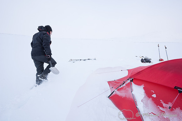Niels Kooyman digs his sled out of the snow at third camp, Dovre
