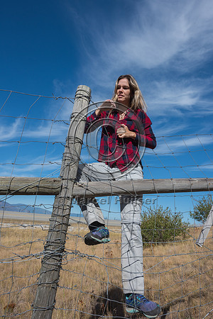 Fernanda Abra climbing a wildlife fence, north of Bonners Ferry,