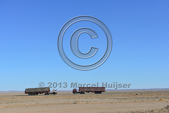 Coal trucks on the paved toll road between Tsagaan khad (White Rock) and Gashuun-Sukhait, Gobi, Mongolia