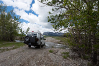Our Ford E350 4x4 camper van on dirt road, crossing a creek, Mon