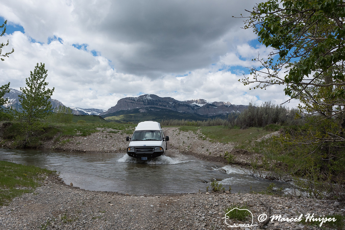 Our Ford E350 4x4 camper van on dirt road, crossing a creek, Mon