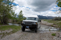 Our Ford E350 4x4 camper van on dirt road, crossing a creek, Mon