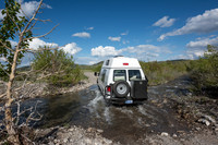 Our Ford E350 4x4 camper van on dirt road, crossing a creek, Mon