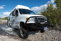 Our Ford E350 4x4 camper van on dirt road, crossing a creek, Mon