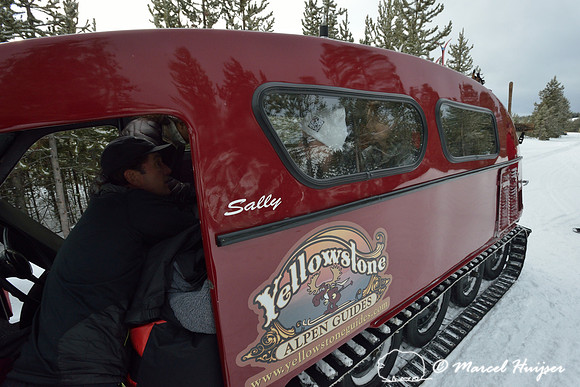 Traveling from West Yellowstone to Old Faithful with a snowcoach in winter, Yellowstone National Park, Wyoming, USA
