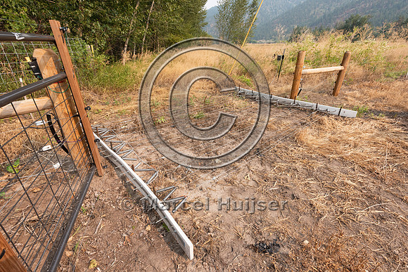 Electrified drive-over barrier to keep black bears out of a melo