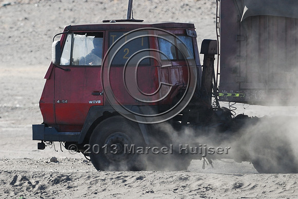 Coal trucks hauling coal to the border and dust, between Tsagaan khad (White Rock) and Gashuun-Sukhait, Gobi, Mongolia
