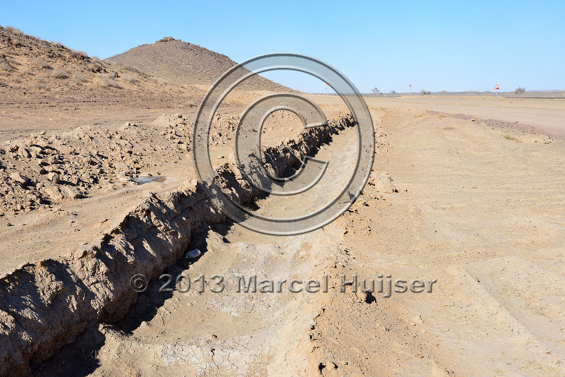 Trench to discourage vehicles from leaving the road, just south of the settlement of Tsagaan khad (White Rock), north of Gashuun-Sukhait, Gobi, Mongolia